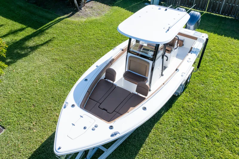 Slide: The Image of 2021 Sea Hunt Gamefish 27 boat with dual Yamaha engines on a trailer. - 77