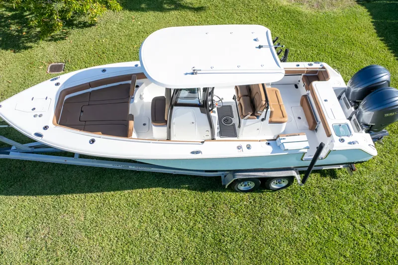 Slide: The Image of 2021 Sea Hunt Gamefish 27 boat with dual Yamaha engines, parked on a trailer. - 78