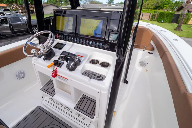 Slide: The Image of 2021 Sea Hunt Gamefish 27 boat console with advanced navigation displays and controls. - 8
