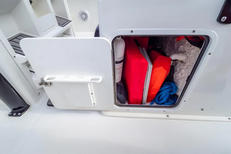 Slide: The Image of Storage compartments on a 2021 Sea Hunt Gamefish 27 Forward Seating boat interior. - 82