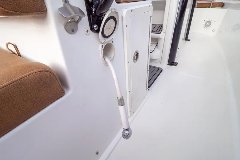 Slide: The Image of 2021 Sea Hunt Gamefish 27 boat with forward seating and sunshade, under a clear blue sky. - 85