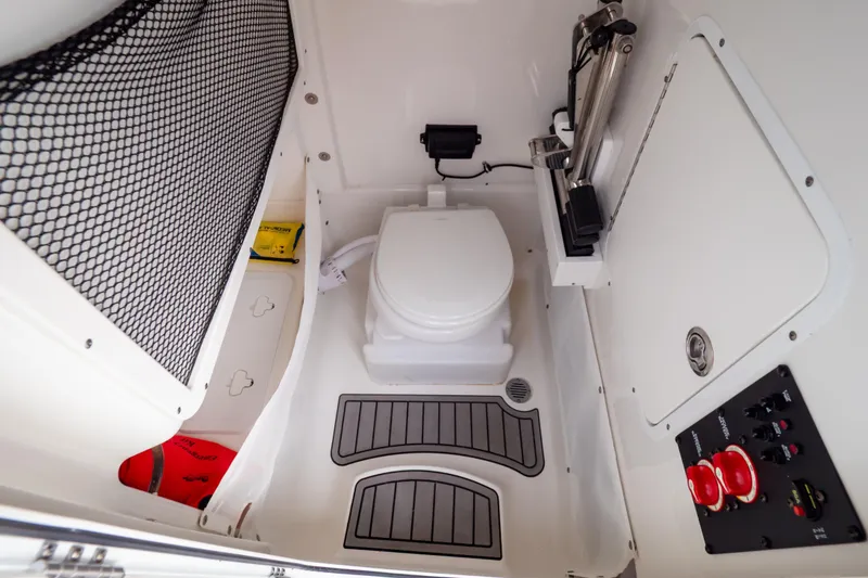 Slide: The Image of 2021 Sea Hunt Gamefish 27 boat interior with toilet and control panel. - 9