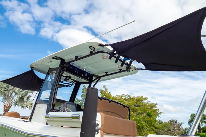 Slide: The Image of 2021 Sea Hunt Gamefish 27 boat with forward seating and sunshade, on trailer. - 90