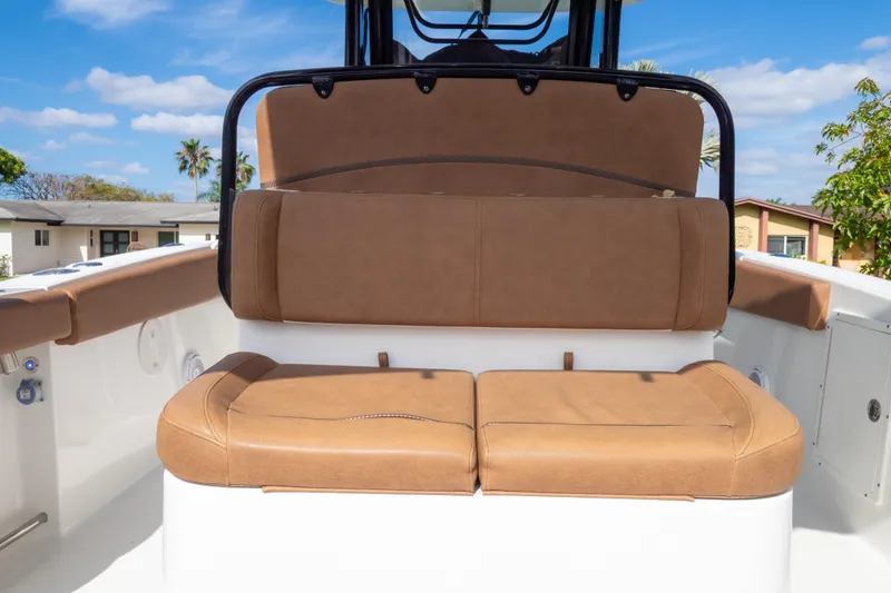 Slide: The Image of 2021 Sea Hunt Gamefish 27 boat with forward seating, featuring a sunshade under a clear blue sky. - 93