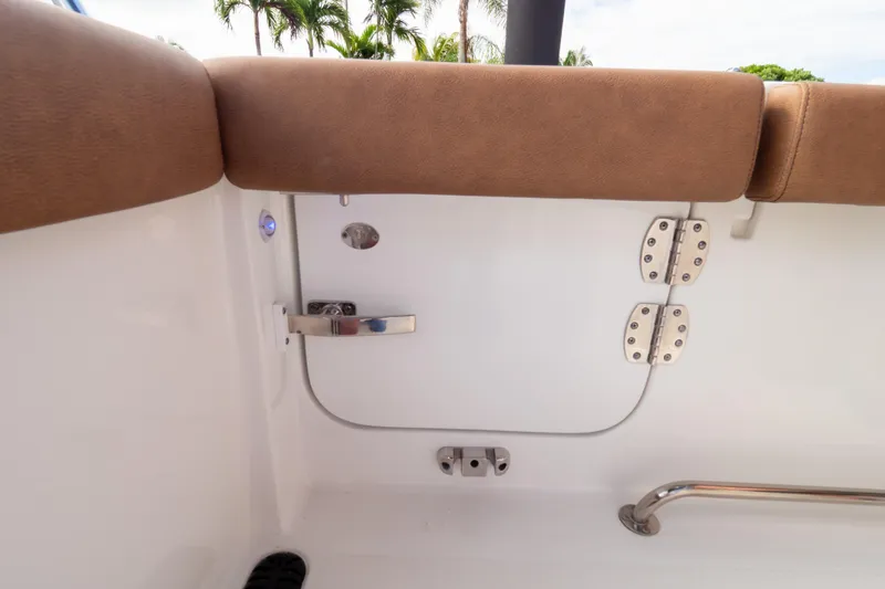 Slide: The Image of 2021 Sea Hunt Gamefish 27 boat interior with brown seating and dual engines. - 97