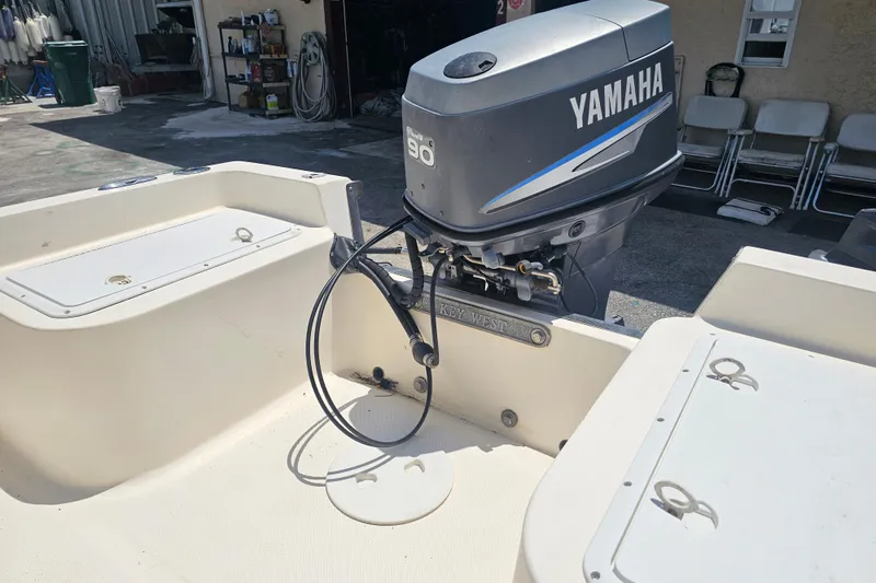 Slide: The Image of 2003 Key West 1720 Sportsman boat with Yamaha 90 outboard motor in a garage setting. - 13