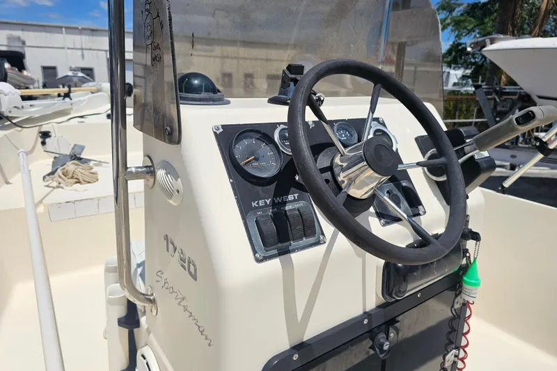 Slide: The Image of 2003 Key West 1720 Sportsman boat dashboard with steering wheel and gauges. - 14