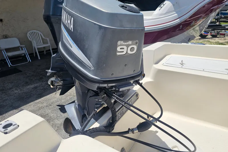Slide: The Image of 2003 Key West 1720 Sportsman with Yamaha 90 outboard motor in a boatyard. - 18
