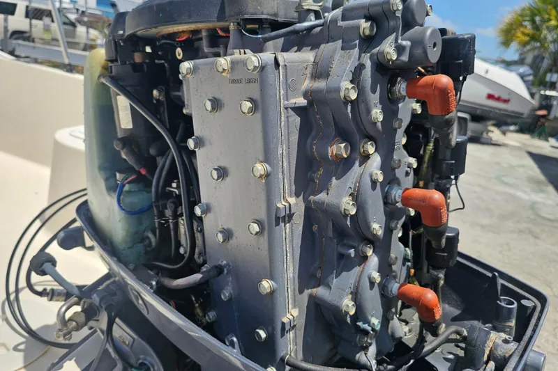 Slide: The Image of Close-up of a 2003 Key West 1720 Sportsman boat engine, showcasing mechanical details. - 21