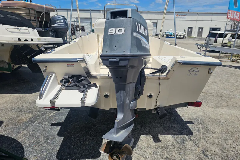 Slide: The Image of 2003 Key West 1720 Sportsman boat with Yamaha 90 outboard motor, parked outdoors. - 5