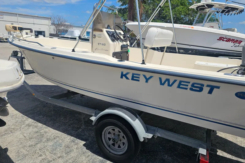 Slide: The Image of 2003 Key West 1720 Sportsman boat on trailer in sunny marina. - 6