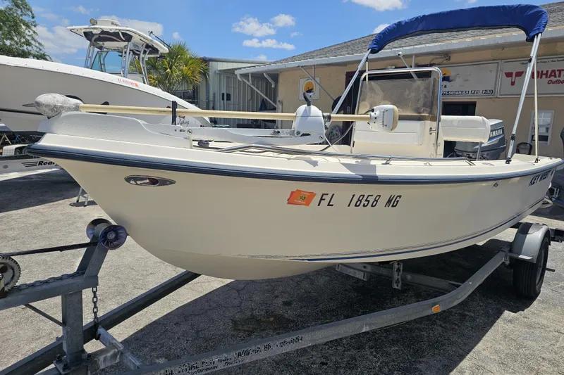 Slide: The Image of 2003 Key West 1720 Sportsman boat on trailer, sunny day, outdoor setting. - 7