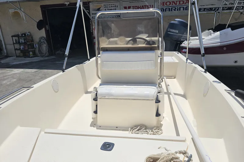 Slide: The Image of 2003 Key West 1720 Sportsman boat interior with seating and Yamaha engine. - 9