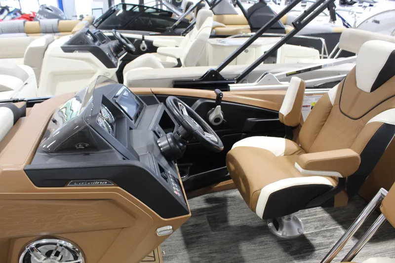 Slide: The Image of Interior of 2026 Avalon 2585 25 Catalina ENT boat with luxurious seating and modern dashboard. - 2
