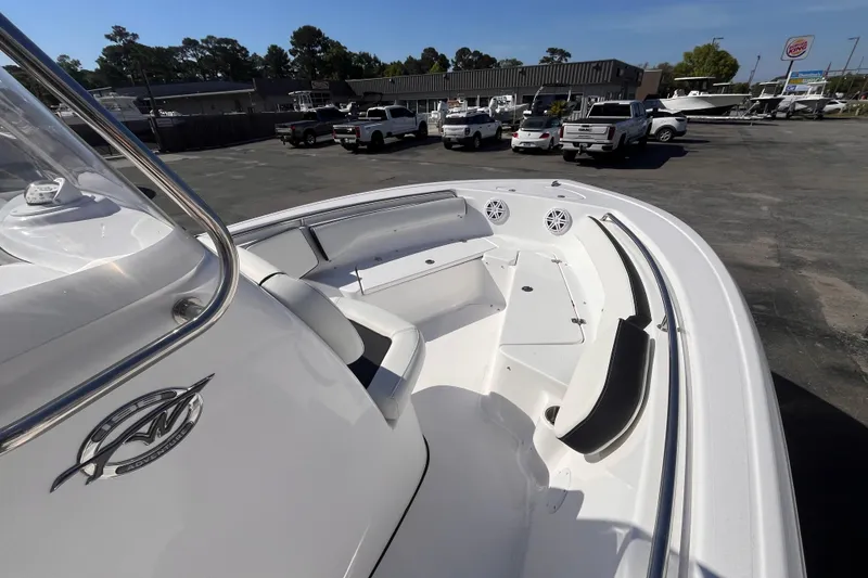 Slide: The Image of Tidewater 198 CC Adventure 2026 boat on lot with cars in background. - 7