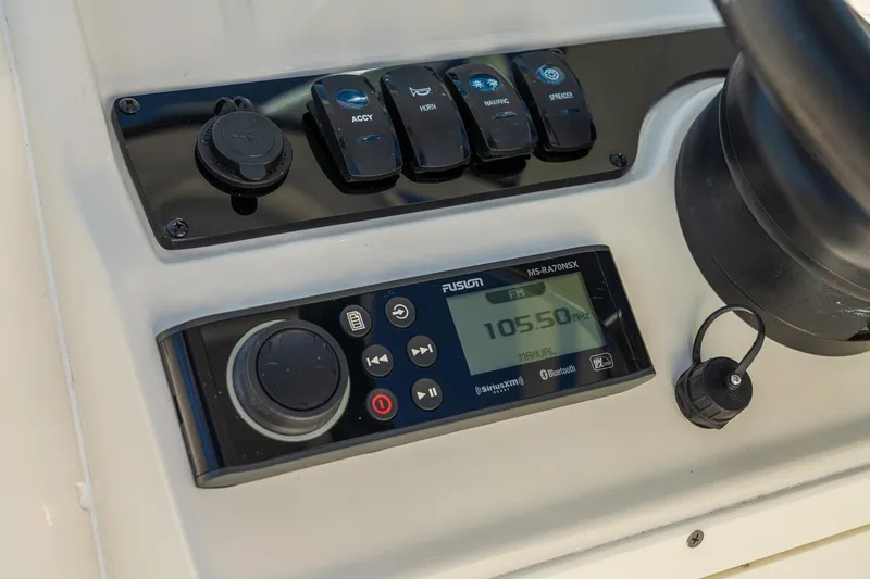 Slide: The Image of Control panel of 2027 Sailfish 245 DC boat with radio and switches. - 7