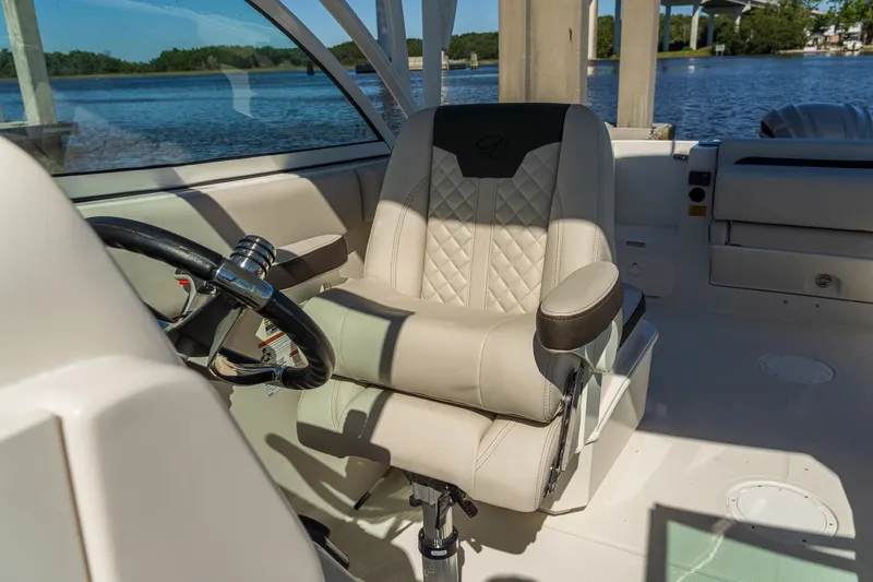 Slide: The Image of Captain's seat on 2027 Sailfish 245 DC boat, featuring luxurious design and waterfront view. - 8