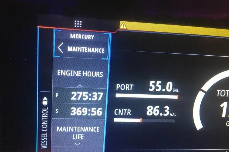 Slide: The Image of Dashboard display showing engine hours and fuel levels for Ocean Master 31, 1999 model. - 11