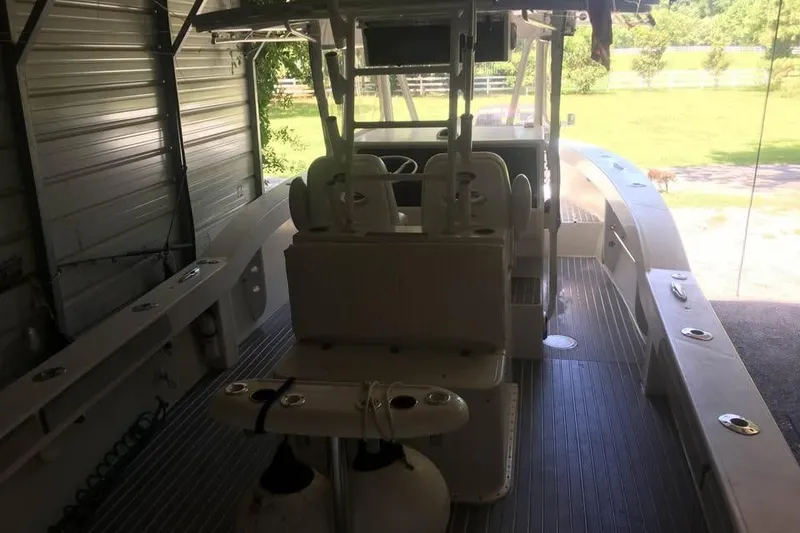 Slide: The Image of Interior view of a 1999 Ocean Master 31 boat in a garage setting. - 12