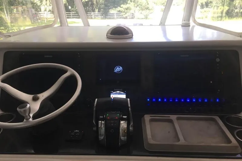 Slide: The Image of Cockpit of a 1999 Ocean Master 31 boat with steering wheel and control panel. - 14