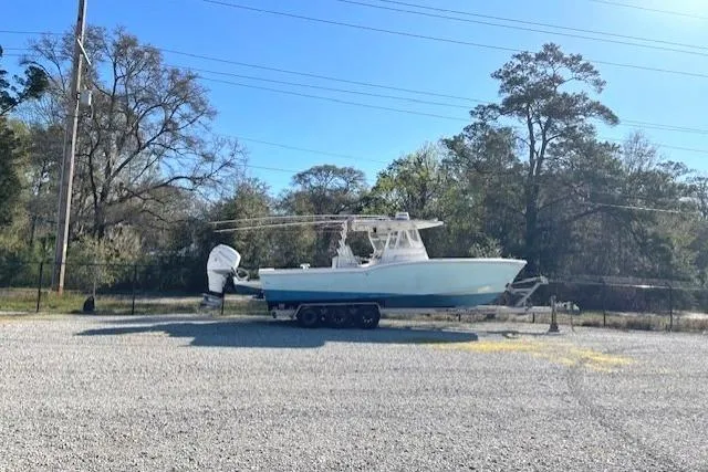 Slide: The Image of 1999 Ocean Master 31 boat on trailer in outdoor setting. - 3
