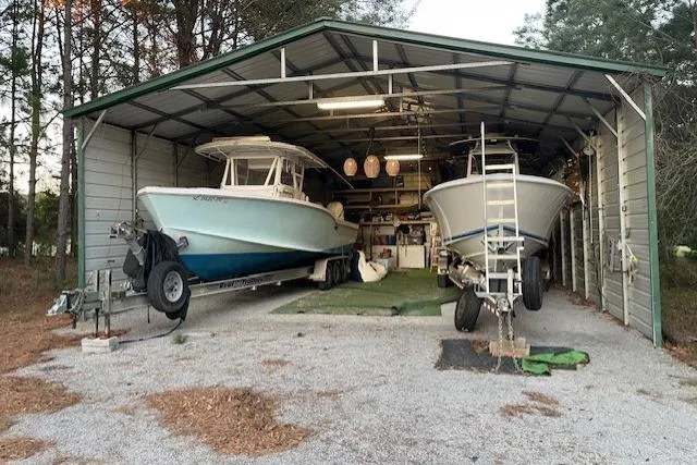 Slide: The Image of Two Ocean Master 31 boats from 1999 stored in a metal garage. - 5