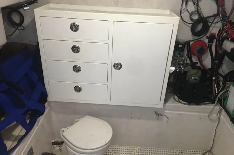 Slide: The Image of Interior of 1999 Ocean Master 31 boat with storage cabinet and marine toilet. - 9