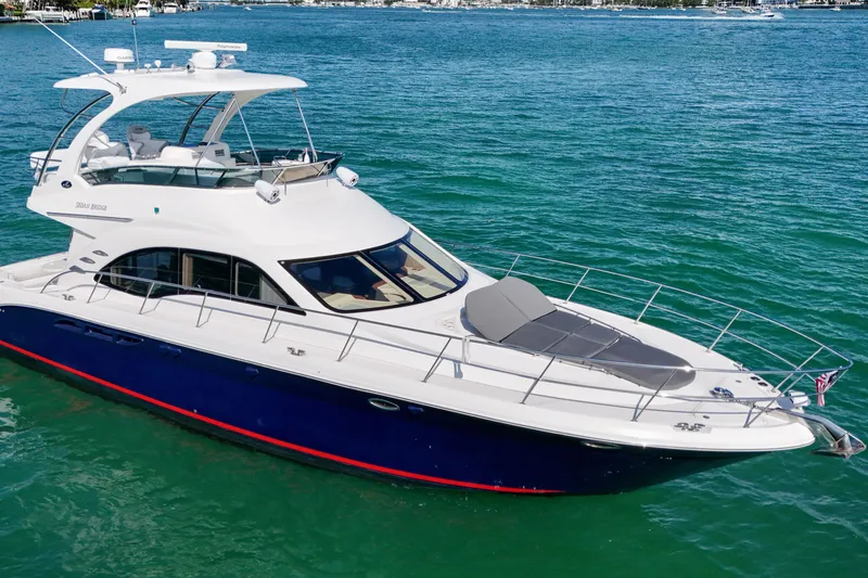 Slide: The Image of 2007 Sea Ray 52 Sedan Bridge yacht cruising on clear blue waters. - 10