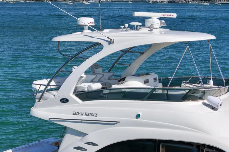 Slide: The Image of 2007 Sea Ray 52 Sedan Bridge yacht on blue water, featuring sleek design and advanced navigation equipment. - 11