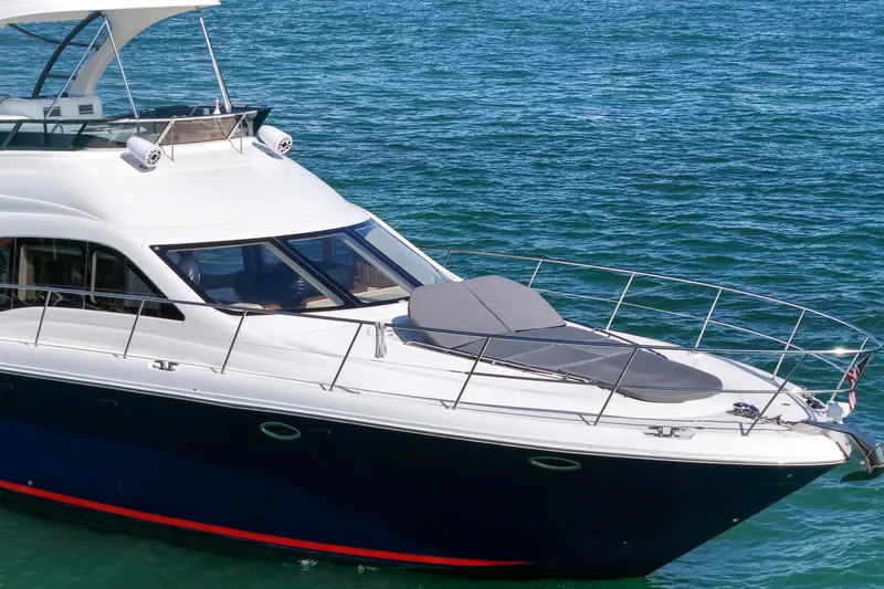 Slide: The Image of 2007 Sea Ray 52 Sedan Bridge yacht on blue ocean waters. - 13