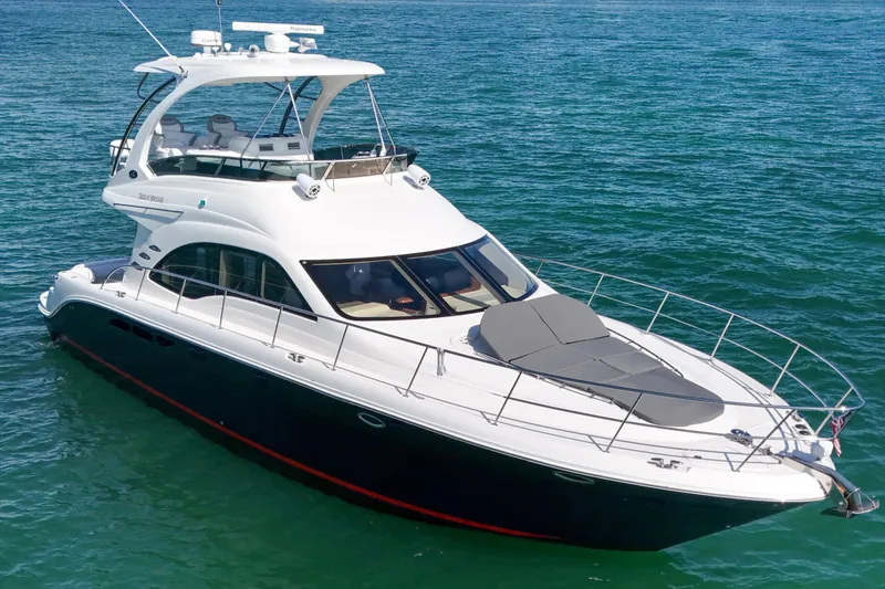 Slide: The Image of 2007 Sea Ray 52 Sedan Bridge yacht cruising on clear blue waters. - 15