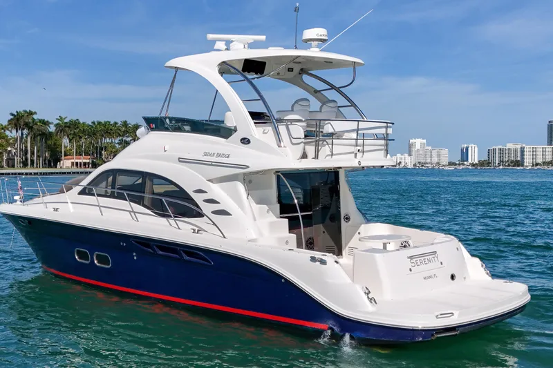 Slide: The Image of 2007 Sea Ray 52 Sedan Bridge yacht cruising in sunny coastal waters. - 19