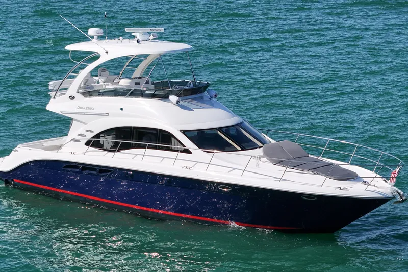 Slide: The Image of 2007 Sea Ray 52 Sedan Bridge yacht cruising on clear blue waters. - 21