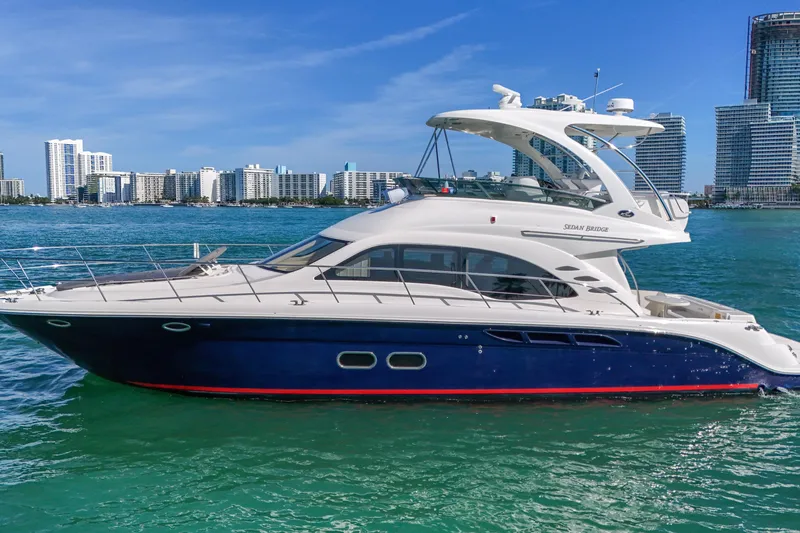 Slide: The Image of 2007 Sea Ray 52 Sedan Bridge yacht cruising near city skyline on a sunny day. - 26