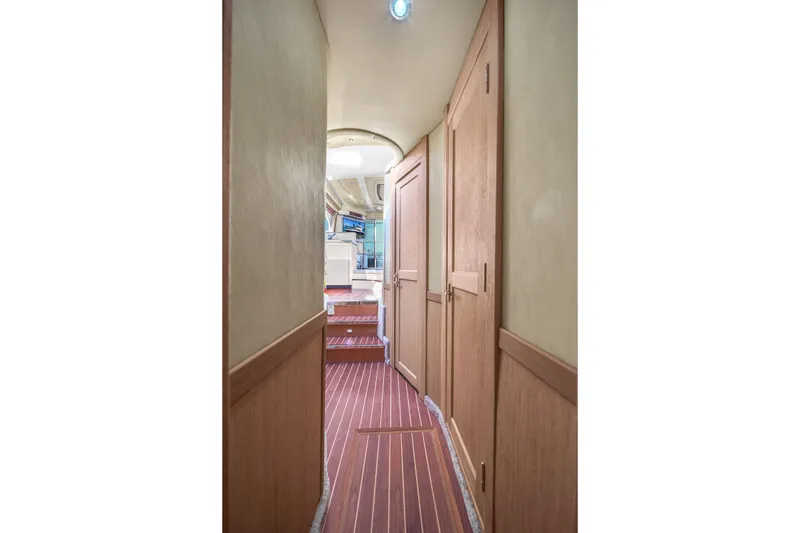 Slide: The Image of Hallway inside 2007 Sea Ray 52 Sedan Bridge yacht with wooden flooring and doors. - 38