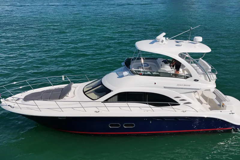 Slide: The Image of 2007 Sea Ray 52 Sedan Bridge yacht cruising on clear blue water. - 4