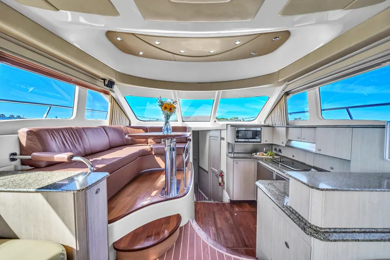 Slide: The Image of Luxurious interior of 2007 Sea Ray 52 Sedan Bridge yacht with modern kitchen and seating area. - 40