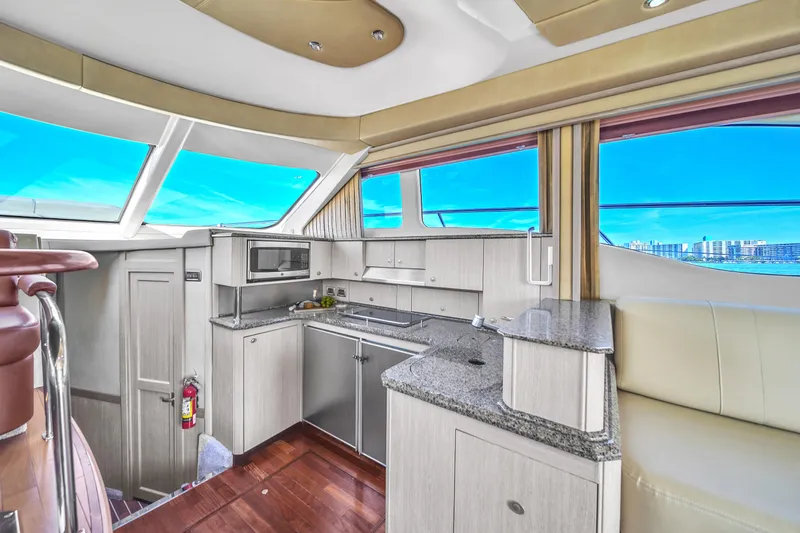 Slide: The Image of Luxurious interior of 2007 Sea Ray 52 Sedan Bridge yacht with modern kitchen amenities. - 41