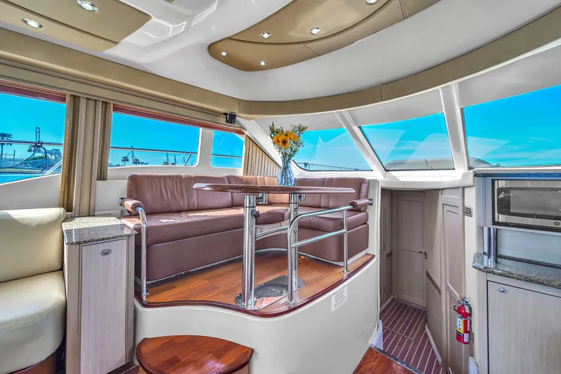 Slide: The Image of Luxurious interior of 2007 Sea Ray 52 Sedan Bridge yacht with leather seating and panoramic windows. - 42