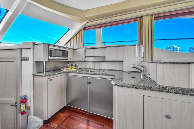 Slide: The Image of Luxurious kitchen interior of 2007 Sea Ray 52 Sedan Bridge yacht with modern amenities. - 43