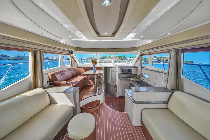 Slide: The Image of Luxurious interior of 2007 Sea Ray 52 Sedan Bridge yacht with panoramic windows and elegant seating. - 44