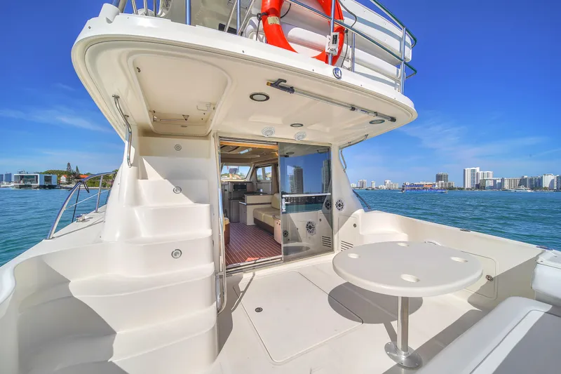 Slide: The Image of 2007 Sea Ray 52 Sedan Bridge yacht with spacious deck and city skyline view. - 49