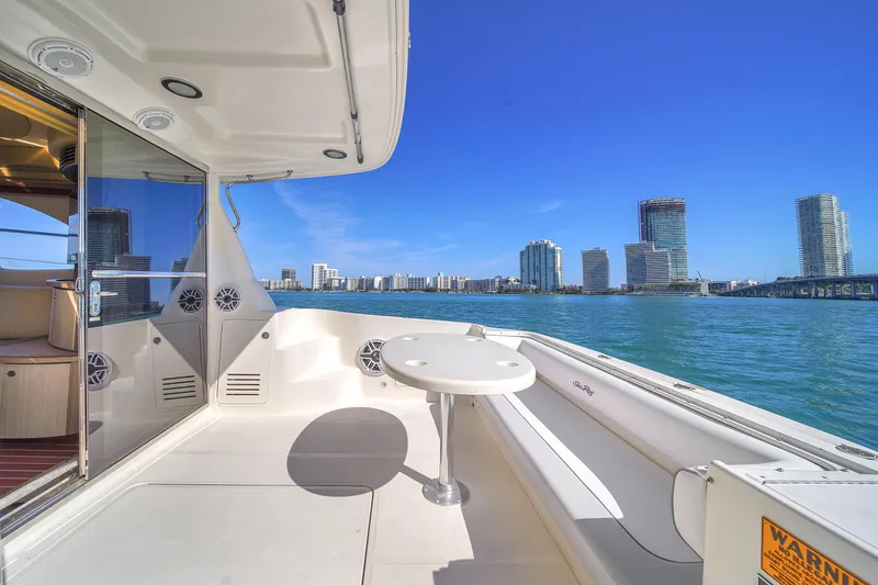 Slide: The Image of 2007 Sea Ray 52 Sedan Bridge yacht with city skyline view on a sunny day. - 53