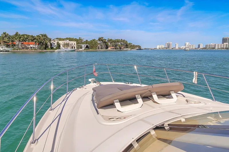 Slide: The Image of 2007 Sea Ray 52 Sedan Bridge cruising on a sunny day with coastal views. - 54
