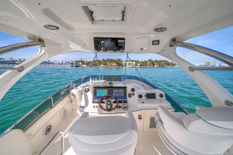 Slide: The Image of 2007 Sea Ray 52 Sedan Bridge yacht interior with modern helm and ocean view. - 58