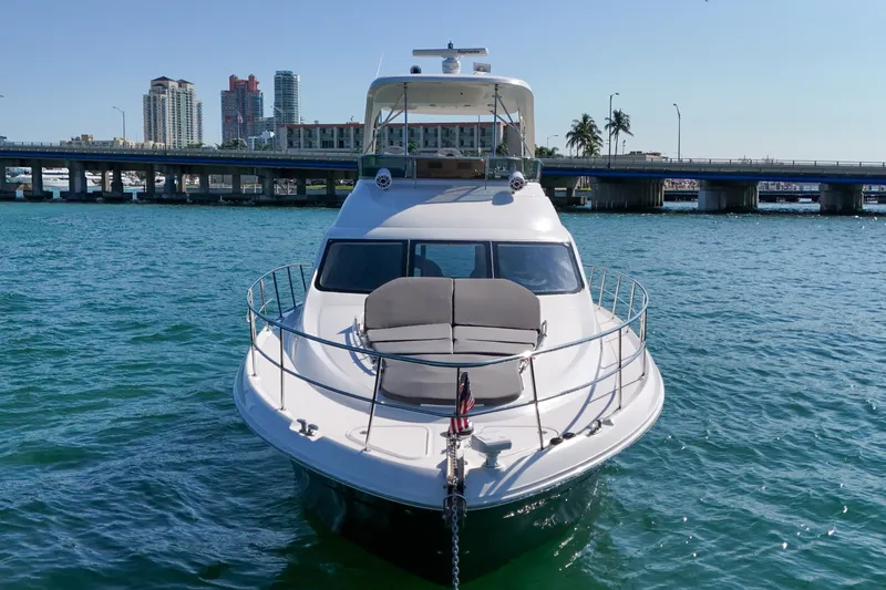 Slide: The Image of 2007 Sea Ray 52 Sedan Bridge yacht on water with cityscape background. - 6