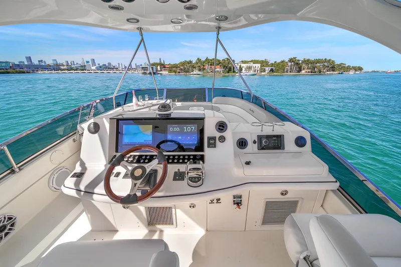 Slide: The Image of 2007 Sea Ray 52 Sedan Bridge yacht helm with ocean view and modern controls. - 61