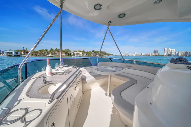 Slide: The Image of Luxurious 2007 Sea Ray 52 Sedan Bridge yacht interior with ocean view and seating area. - 62