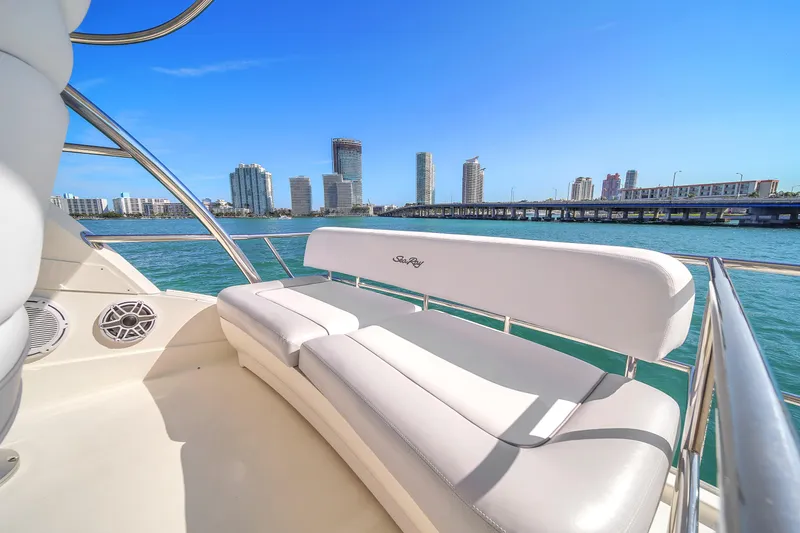 Slide: The Image of 2007 Sea Ray 52 Sedan Bridge yacht with city skyline and blue water backdrop. - 66