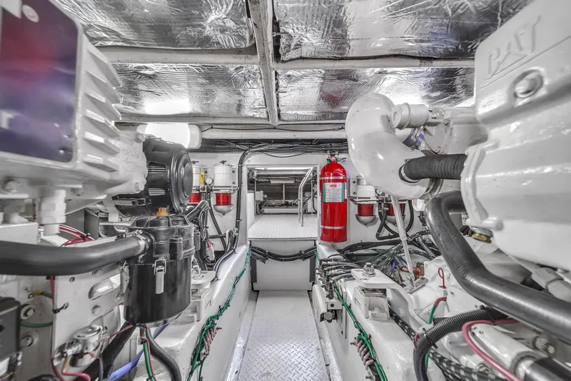 Slide: The Image of Engine room of a 2007 Sea Ray 52 Sedan Bridge yacht, featuring mechanical components. - 69
